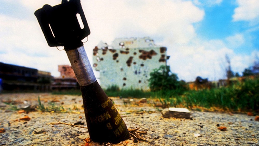 Unexploded ordnance in Quito, Angola. In hindsight, I don't know what I was thinking lying on the ground beside an unexploded bomb.