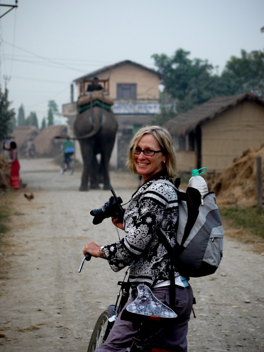 Penny on bike in Nepal with elephant